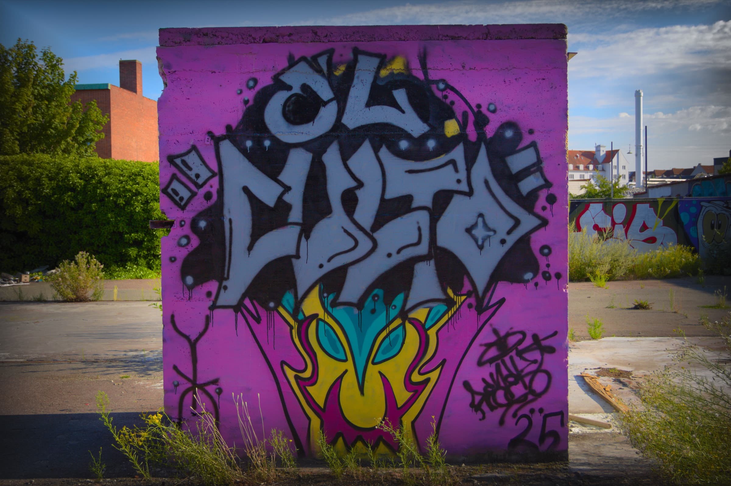 An El Culto mural, sprayed on a purple concrete wall
